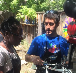 Ryan works with a customer to fix their bike.