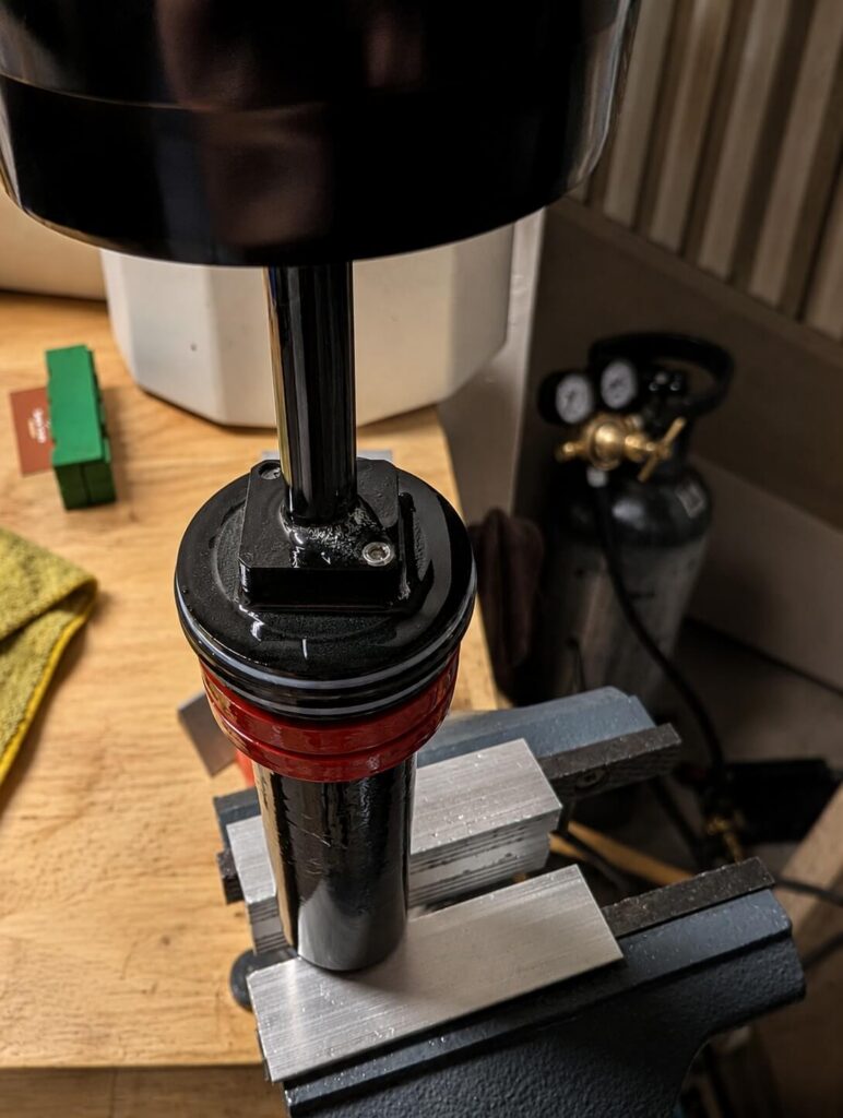 Mountain bike shock clamped for suspension service