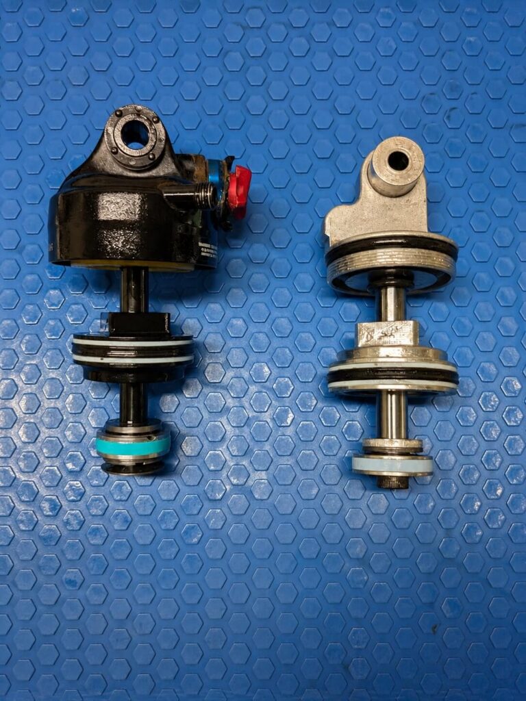 Two rear shock damper assemblies during suspension service
